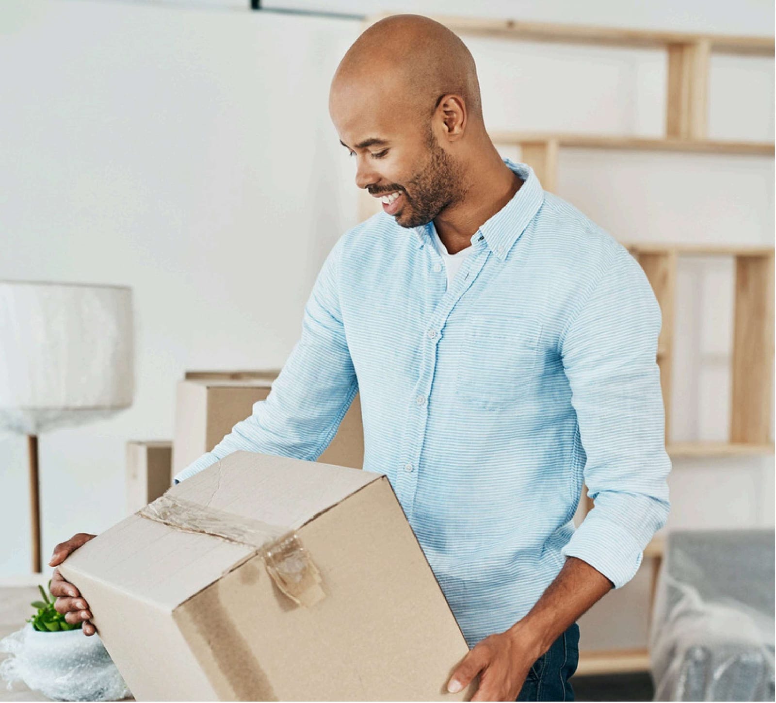 A person carrying a moving box on closing day